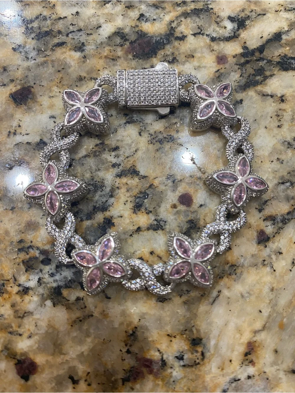 Sterling silver and moissanite floral bracelet with multi colored stones.